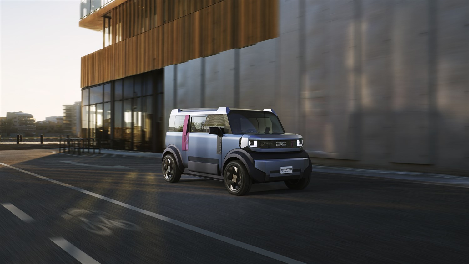 Концепт автомобил Dacia Hipster паркиран пред модерна зграда со големи стаклени површини на зајдисонце.